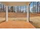Covered outdoor patio area with a view of the wooded backyard at 261 Martin Spring Rd, Lawrenceville, GA 30045