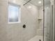 Shower featuring glass enclosure, stone look tile surround, and vinyl floors at 261 Martin Spring Rd, Lawrenceville, GA 30045