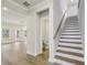 Entryway with staircase, light wood floors, and access to a half bath at 261 Martin Spring Rd, Lawrenceville, GA 30045