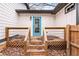 Elevated wooden deck with stairs, blue door, and metal railings at 883 Gaston Sw St, Atlanta, GA 30310
