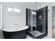 Elegant bathroom with freestanding tub and a black and white tile shower at 883 Gaston Sw St, Atlanta, GA 30310