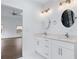 Bright bathroom featuring double vanity with modern mirrors and lighting, and neutral countertop at 883 Gaston Sw St, Atlanta, GA 30310