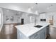 Bright, open kitchen featuring white cabinets, quartz countertops, an island, and stainless steel appliances at 883 Gaston Sw St, Atlanta, GA 30310