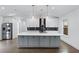 Modern kitchen featuring white cabinets, quartz countertops, a kitchen island, and stainless steel appliances at 883 Gaston Sw St, Atlanta, GA 30310