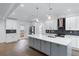 Modern kitchen with white cabinets, quartz countertops, and stainless steel appliances at 883 Gaston Sw St, Atlanta, GA 30310