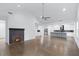 Bright and spacious living room featuring a fireplace, wood floors, and an open floor plan to the kitchen at 883 Gaston Sw St, Atlanta, GA 30310