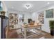 Comfortable home office space featuring a fireplace, built-in shelving, and natural light from two windows at 883 Gaston Sw St, Atlanta, GA 30310