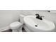 Powder room with pedestal sink, white toilet, and black faucet at 281 Martin Spring Rd, Lawrenceville, GA 30045