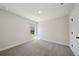 Well-lit bedroom featuring neutral carpet, white trim, and window view at 281 Martin Spring Rd, Lawrenceville, GA 30045
