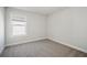 Bright bedroom featuring neutral carpet, white trim, and window view at 281 Martin Spring Rd, Lawrenceville, GA 30045