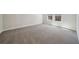 Spacious bedroom with neutral carpet, natural light, and base molding throughout the room at 281 Martin Spring Rd, Lawrenceville, GA 30045