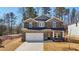 Charming two-story home featuring stone accents, a two-car garage and a well-manicured front lawn at 281 Martin Spring Rd, Lawrenceville, GA 30045