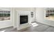 Beautiful fireplace featuring a white mantel, large windows and a marble hearth, with hardwood floors at 281 Martin Spring Rd, Lawrenceville, GA 30045