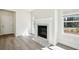 Elegant fireplace with a marble mantel and large windows offering natural light and backyard views at 281 Martin Spring Rd, Lawrenceville, GA 30045