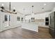 Modern kitchen with white cabinets, stainless steel appliances, and granite countertops open to breakfast area at 281 Martin Spring Rd, Lawrenceville, GA 30045