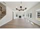 Light-filled living room with hardwood floors, modern chandelier, fireplace, and large windows at 281 Martin Spring Rd, Lawrenceville, GA 30045