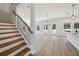Open concept living area with wood staircase, stainless steel appliances, and a chandelier at 281 Martin Spring Rd, Lawrenceville, GA 30045