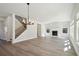 Spacious living area featuring hardwood floors, a fireplace, large windows, and staircase at 281 Martin Spring Rd, Lawrenceville, GA 30045