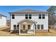 White two-story home featuring a covered patio and large windows, perfect for enjoying the backyard view at 281 Martin Spring Rd, Lawrenceville, GA 30045