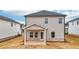 Exterior view of home featuring a covered patio and a well-maintained backyard at 711 Lily Blossom Path, Lawrenceville, GA 30045