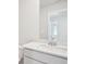 Bathroom sink featuring a large mirror, white counter, and a faucet at 711 Lily Blossom Path, Lawrenceville, GA 30045