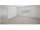 Empty bedroom with plush neutral carpet, natural light and views at 711 Lily Blossom Path, Lawrenceville, GA 30045