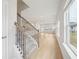 Bright entryway featuring wood floors, a staircase with metal railings and large windows offering natural light at 711 Lily Blossom Path, Lawrenceville, GA 30045
