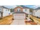 Charming two-story home featuring a brick and stone facade, attached two-car garage and a manicured front lawn at 711 Lily Blossom Path, Lawrenceville, GA 30045