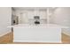 Modern kitchen island with a white countertop, stainless steel appliances and white cabinetry at 711 Lily Blossom Path, Lawrenceville, GA 30045