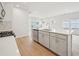 Kitchen view featuring an island with stainless steel appliances, faucet, and sink and bright kitchen with white paint at 711 Lily Blossom Path, Lawrenceville, GA 30045
