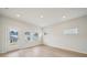 Bright living room featuring wood floors, recessed lighting and ample windows offering plenty of natural light at 711 Lily Blossom Path, Lawrenceville, GA 30045