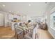 Virtually staged open living space features wood floors, recessed lights, and dining and living room areas at 711 Lily Blossom Path, Lawrenceville, GA 30045