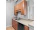 Modern kitchen with wood cabinets and black appliances at 32 Peachtree Nw St # 804, Atlanta, GA 30303