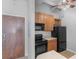 Modern kitchen with wood cabinets and black appliances at 32 Peachtree Nw St # 804, Atlanta, GA 30303