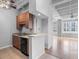 Modern kitchen with wood cabinets and black appliances at 32 Peachtree Nw St # 804, Atlanta, GA 30303