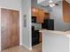 Modern kitchen with wood cabinets and black appliances at 32 Peachtree Nw St # 804, Atlanta, GA 30303