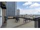 Rooftop deck with city views, tables, and chairs at 32 Peachtree Nw St # 804, Atlanta, GA 30303