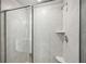 Modern bathroom with glass door shower and tiled walls at 602 Wallace Oak Ln, Lawrenceville, GA 30045