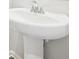 Close-up of white bathroom pedestal sink with chrome faucet. The wall behind it is painted light gray at 602 Wallace Oak Ln, Lawrenceville, GA 30045