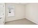 Comfortable bedroom with plush carpet, natural light, and neutral finishes at 602 Wallace Oak Ln, Lawrenceville, GA 30045