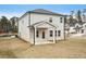 Exterior view featuring a covered patio, light gray siding, and a well-maintained lawn at 602 Wallace Oak Ln, Lawrenceville, GA 30045