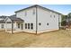 Rear exterior view with light gray siding, a covered patio, and a well-maintained lawn at 602 Wallace Oak Ln, Lawrenceville, GA 30045