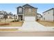 Two-story home with stone and blue siding, a two-car garage, and a well-manicured lawn at 602 Wallace Oak Ln, Lawrenceville, GA 30045