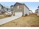 Two-story home with stone and gray siding, a two-car garage, and a driveway at 602 Wallace Oak Ln, Lawrenceville, GA 30045