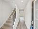 A bright hallway with hardwood floors, a staircase, and access to other rooms at 602 Wallace Oak Ln, Lawrenceville, GA 30045