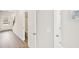 Hallway with hardwood floors, stairs, white walls and a half bathroom at 602 Wallace Oak Ln, Lawrenceville, GA 30045