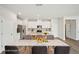 Kitchen with island, seating, dining table, stainless steel appliances and white cabinets at 602 Wallace Oak Ln, Lawrenceville, GA 30045