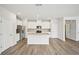 Bright kitchen with stainless steel appliances, island, hardwood floors and white cabinets at 602 Wallace Oak Ln, Lawrenceville, GA 30045