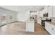 Bright kitchen with white cabinets, stainless steel appliances, and a center island, adjacent to the living area at 602 Wallace Oak Ln, Lawrenceville, GA 30045
