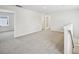 A well-lit loft area featuring neutral carpet and walls, with doorways leading to other rooms at 602 Wallace Oak Ln, Lawrenceville, GA 30045
